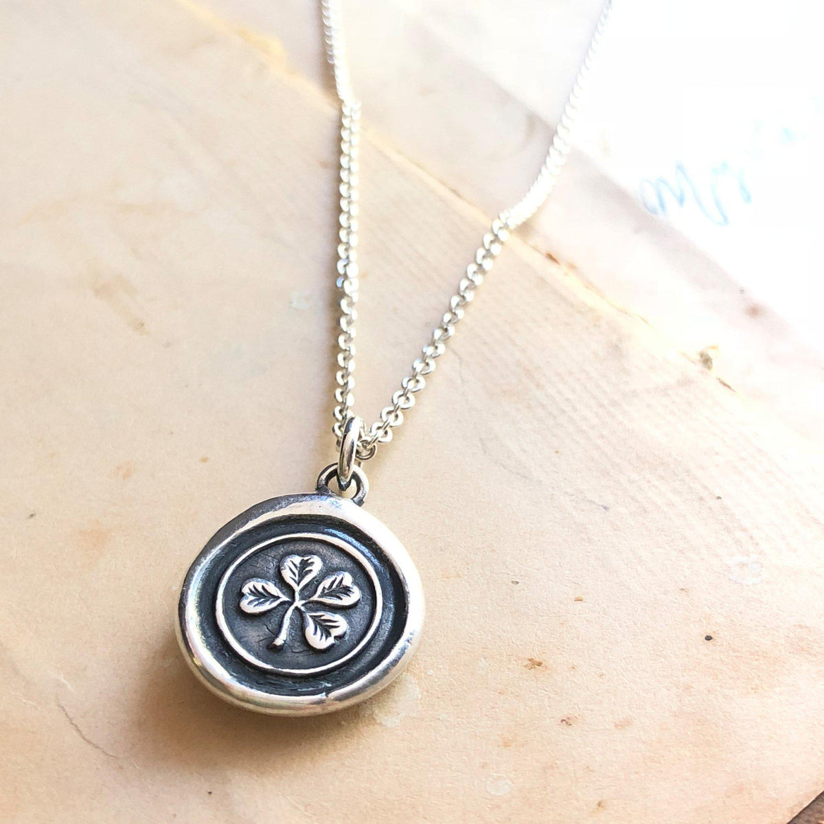 clover wax seal necklace with a silver chain
