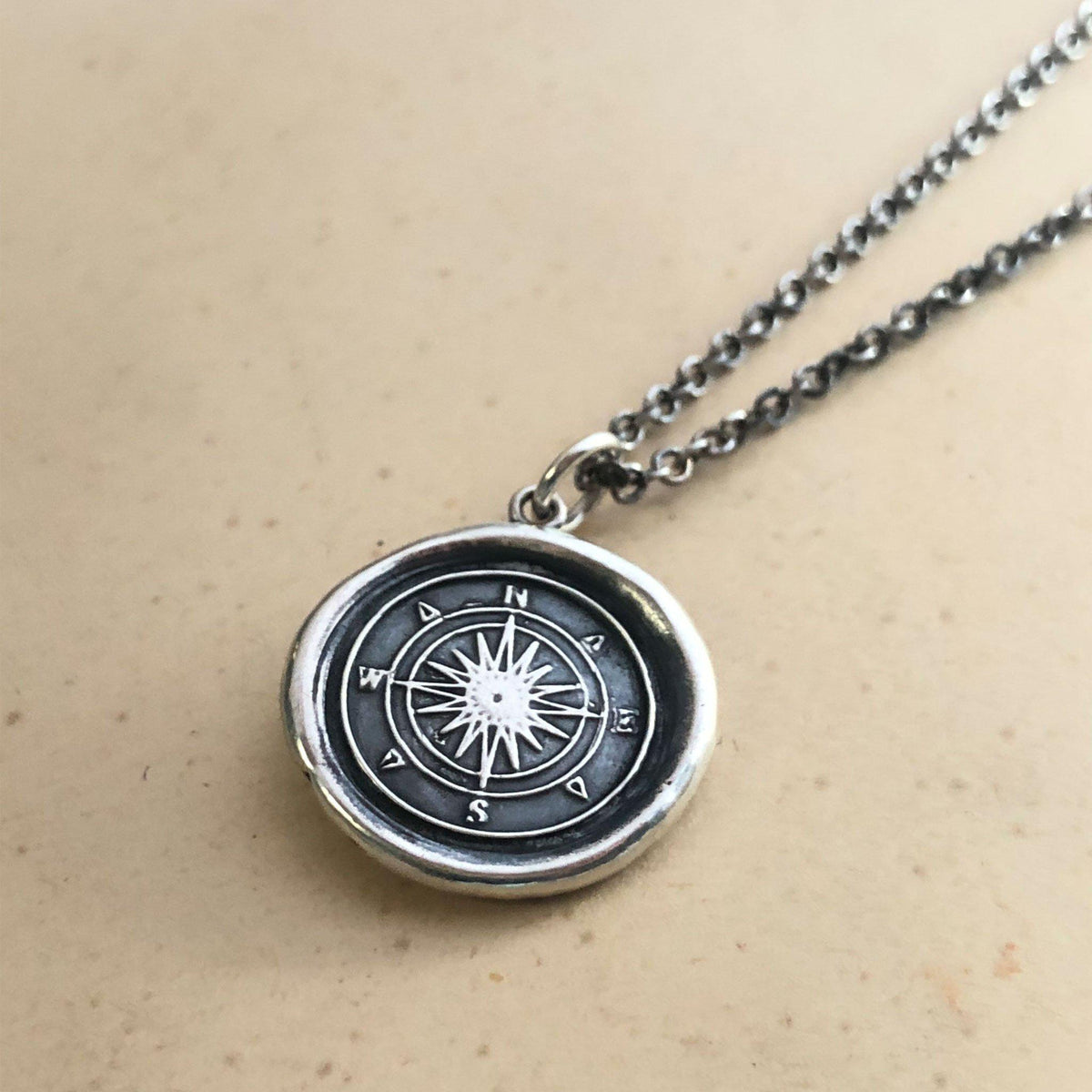 Compass wax seal necklace dark chain close up