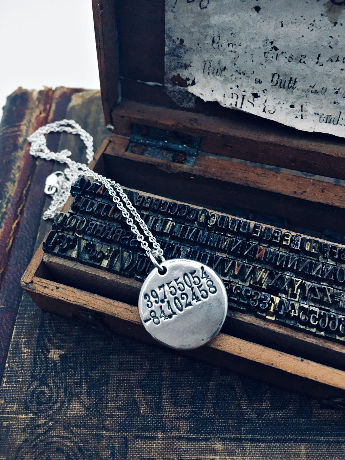 Compass wax seal necklace with coordinates on the back