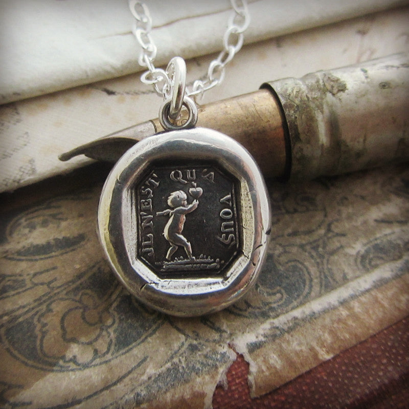 Cupid heart wax seal necklace over a pen