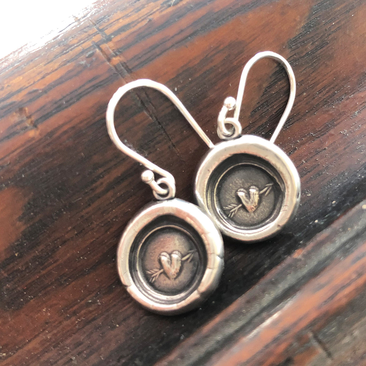 Arrow and hear wax seal earrings side by side