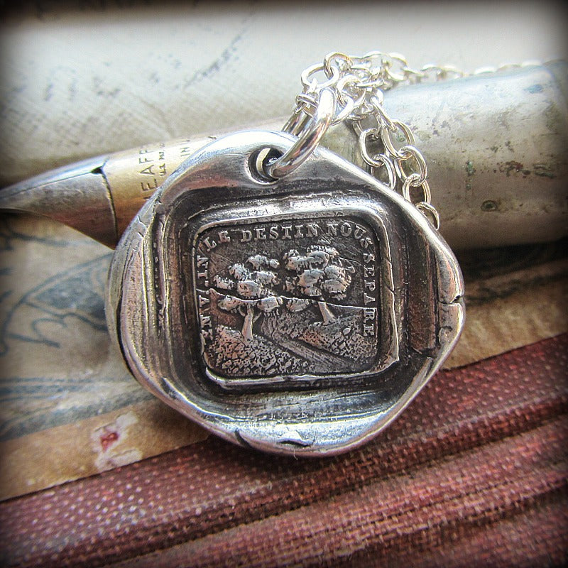 Delusion wax seal necklace over a pen