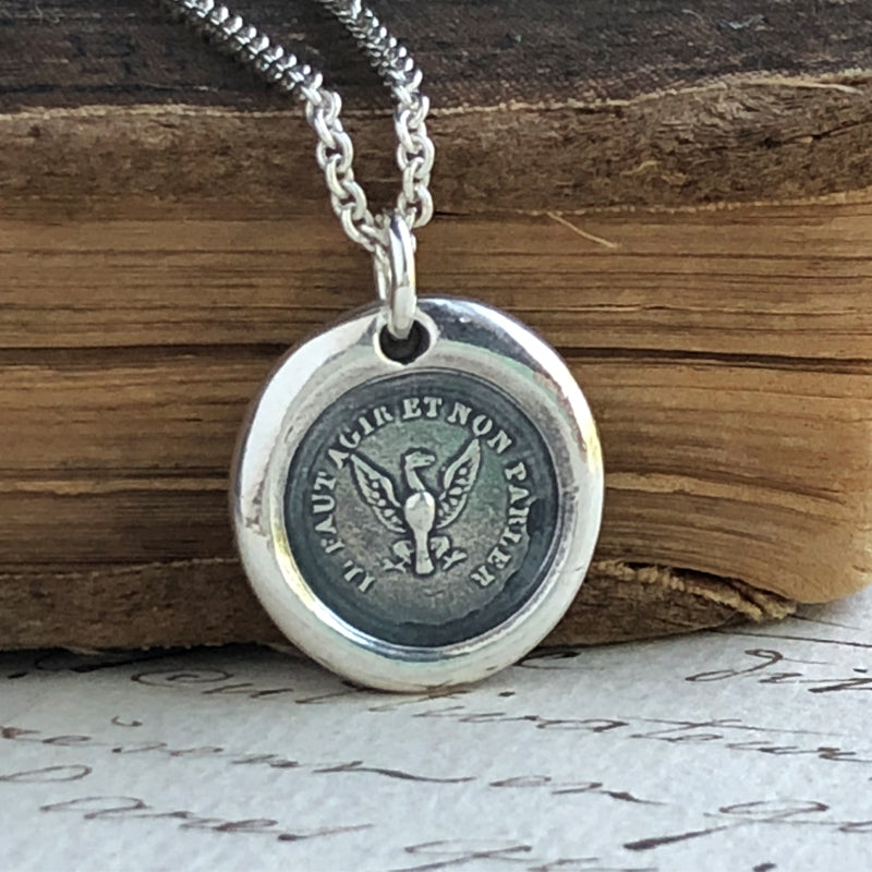 Eagle wax seal with silver chain on wood