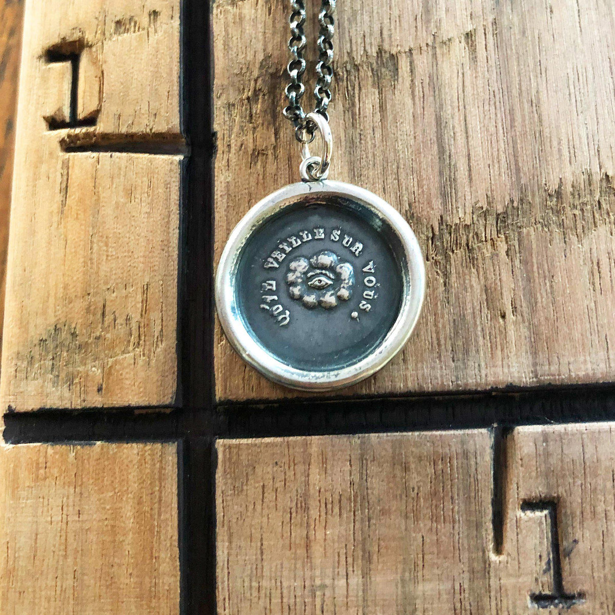 Eye of providence wax seal on wood