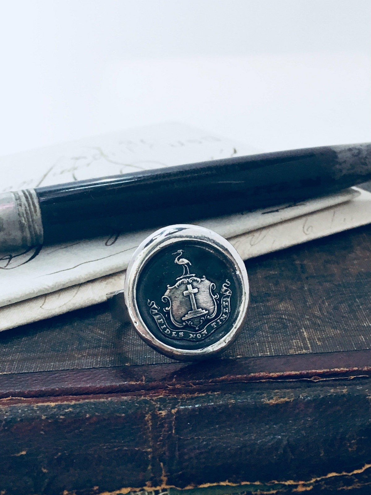 Faith wax seal ring on a desk