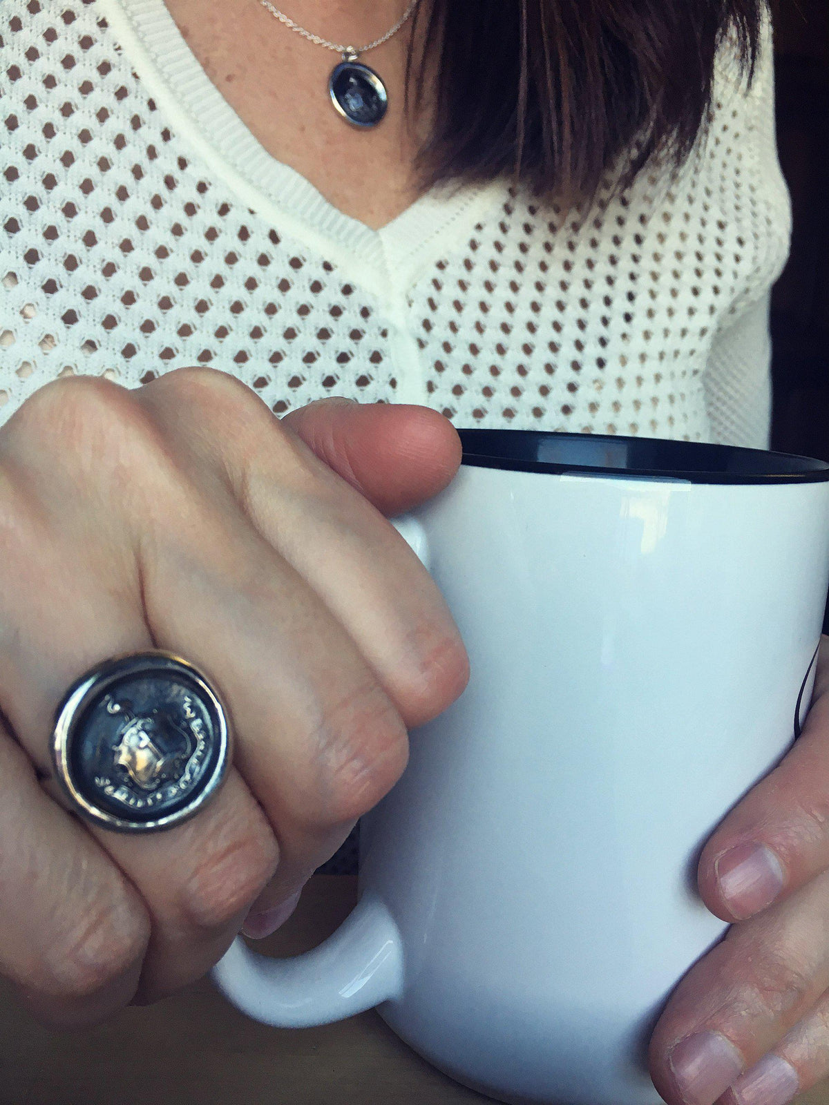 Faith wax seal ring on model holding a coffee cup