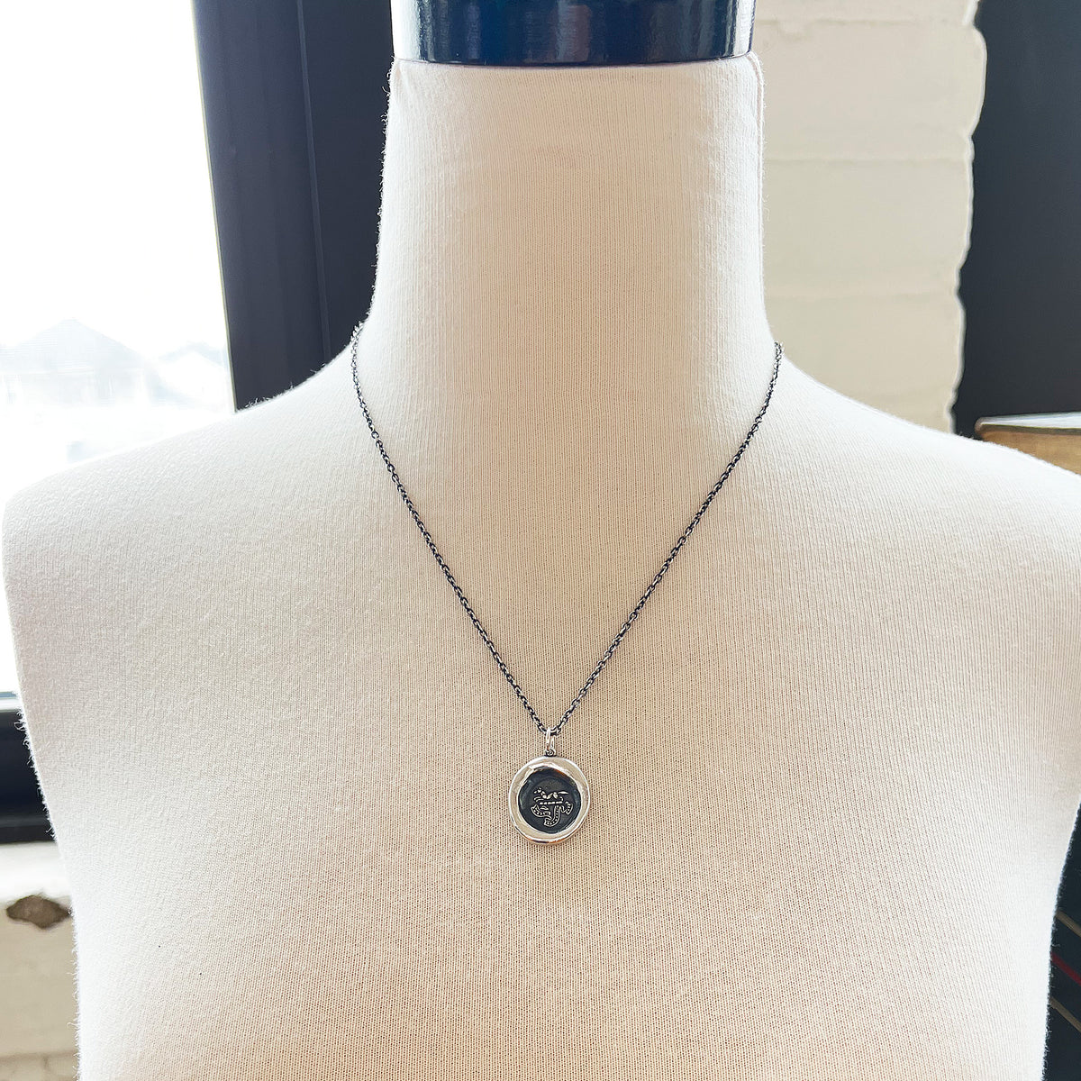 Fox charm wax seal necklace on a mannequin