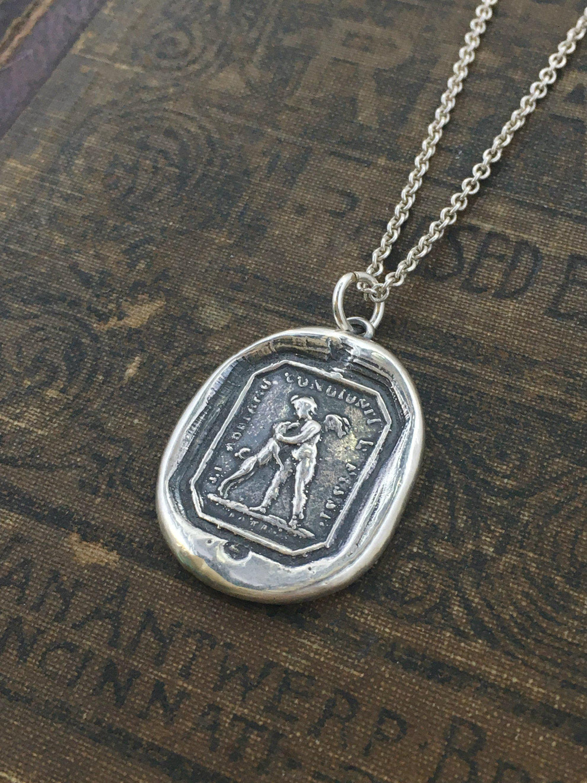 Friendship wax seal necklace close up with a silver chain