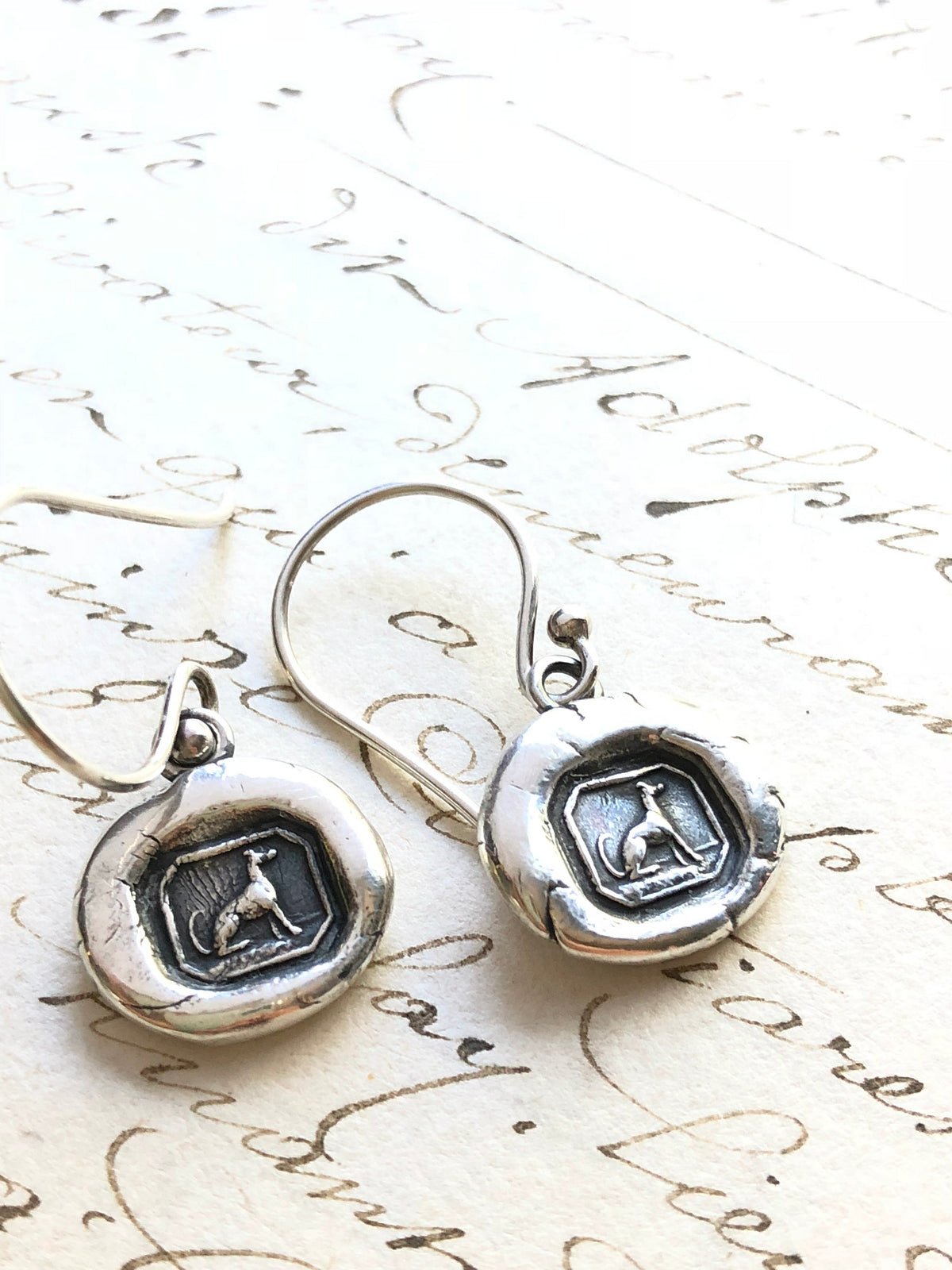 Greyhound wax seal earrings side by side