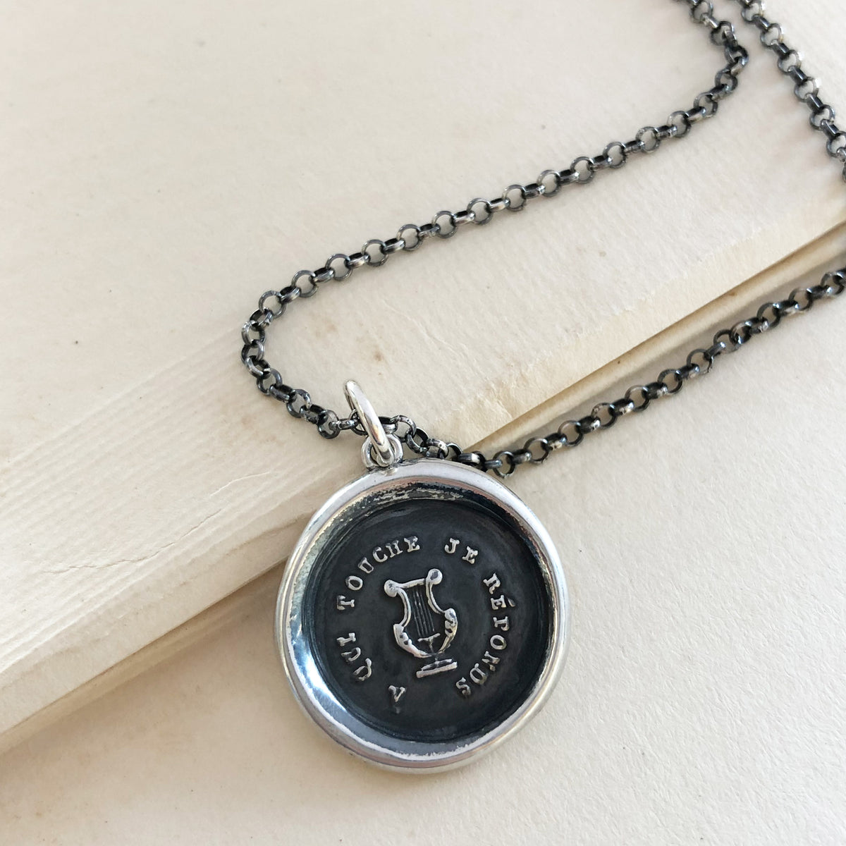 Harp wax seal necklace with a dark chain