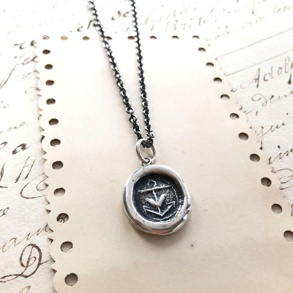 Heart Anchor wax seal with dark silver chain on paper