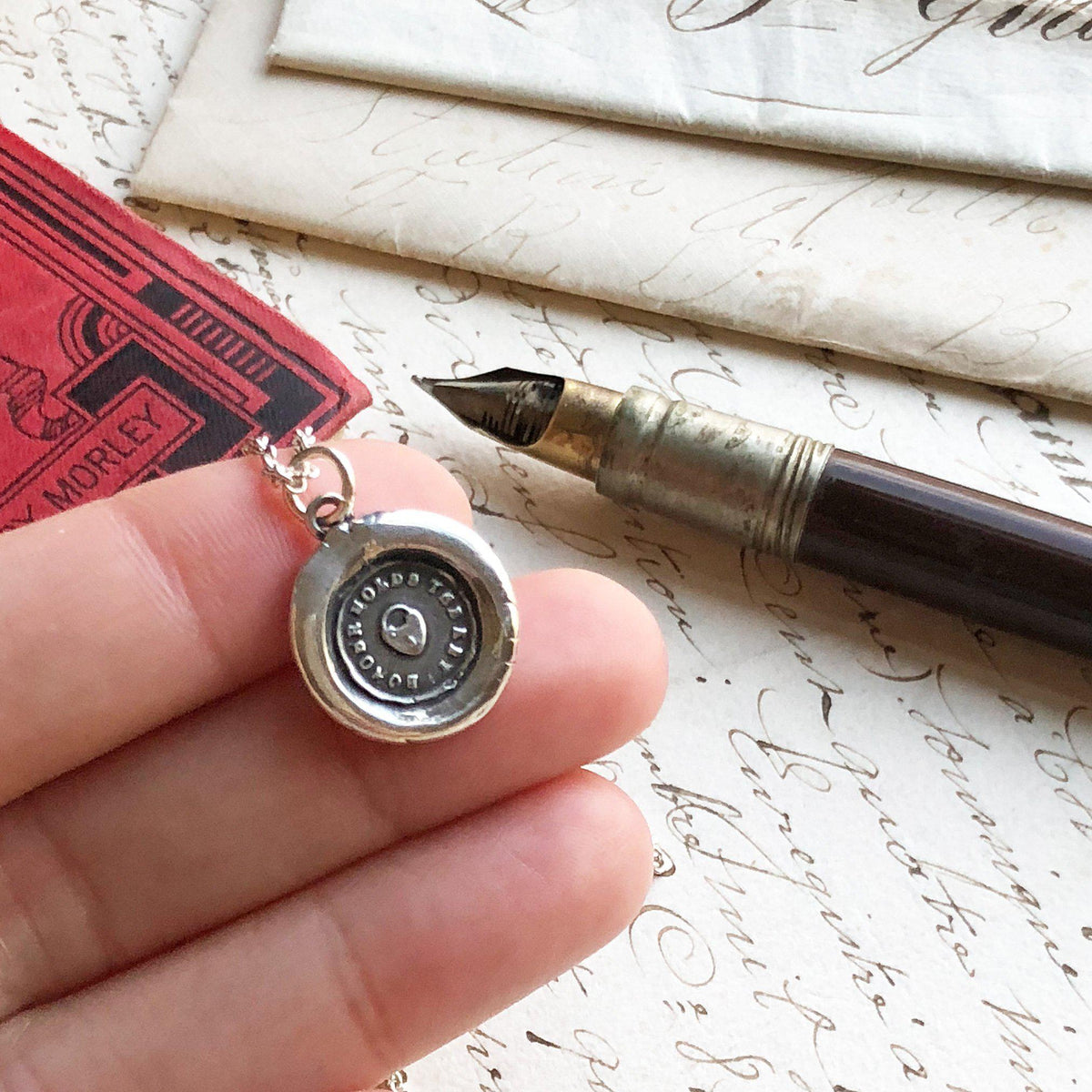 heart padlock wax seal necklace in hand