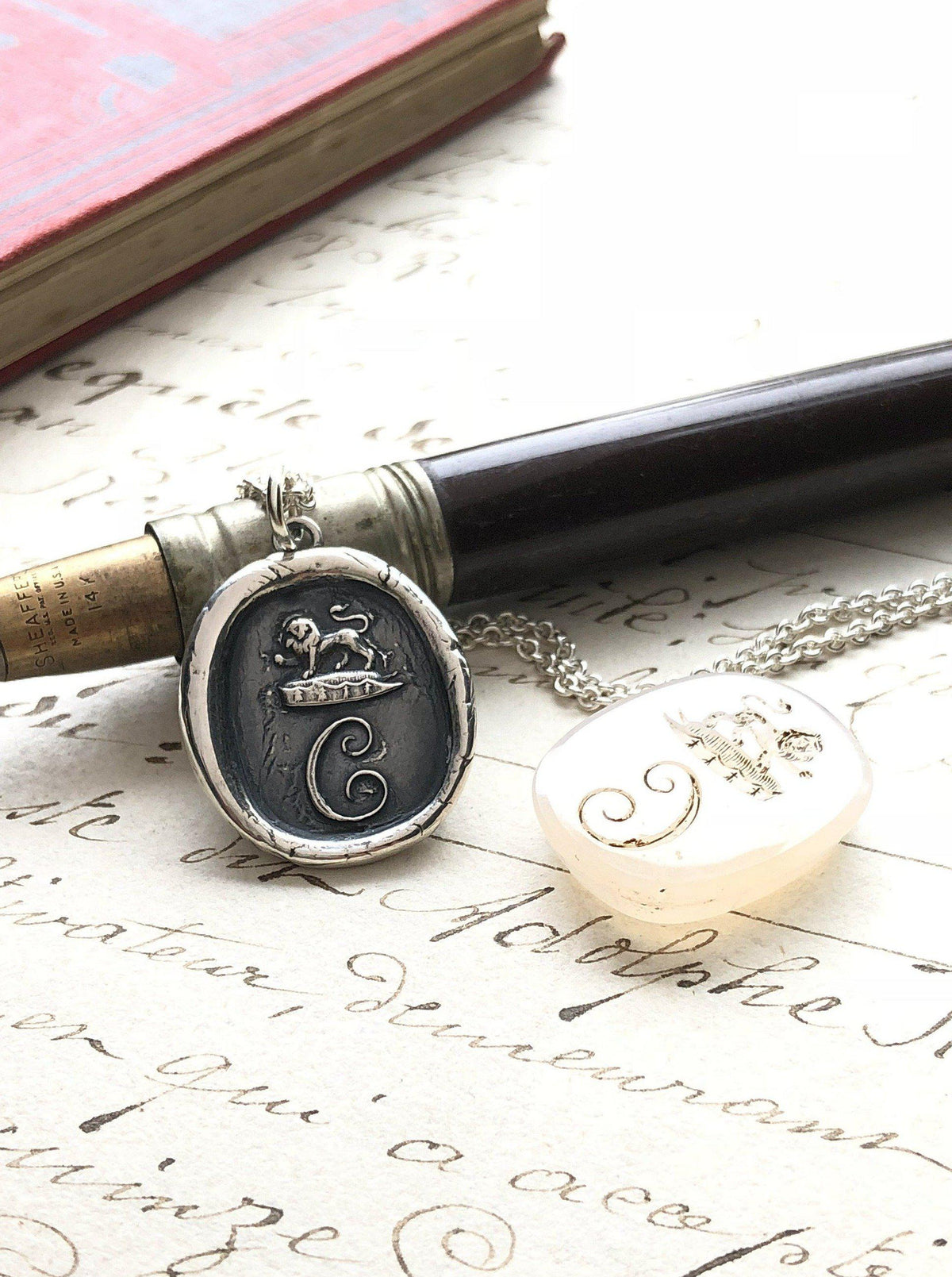 Initial wax seal necklace on a pen