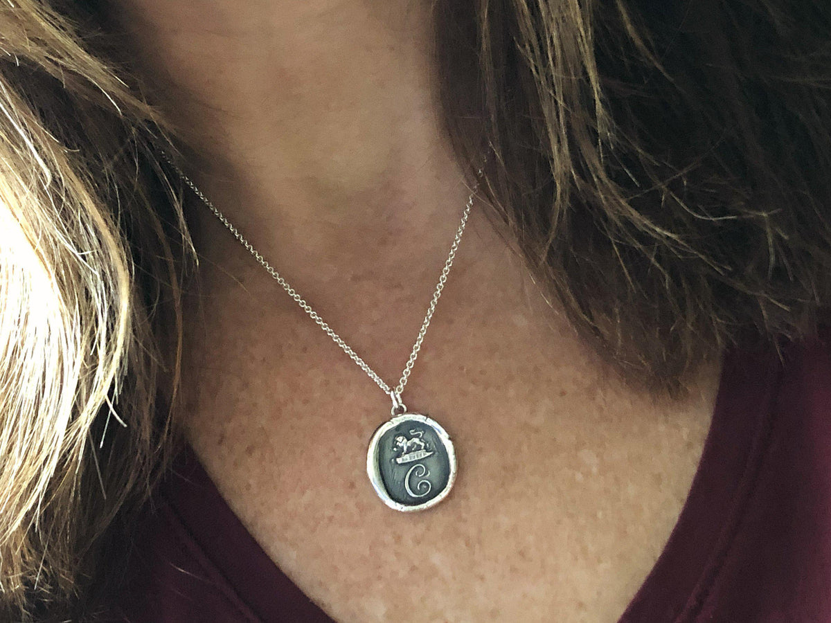 Initial wax seal necklace on a model