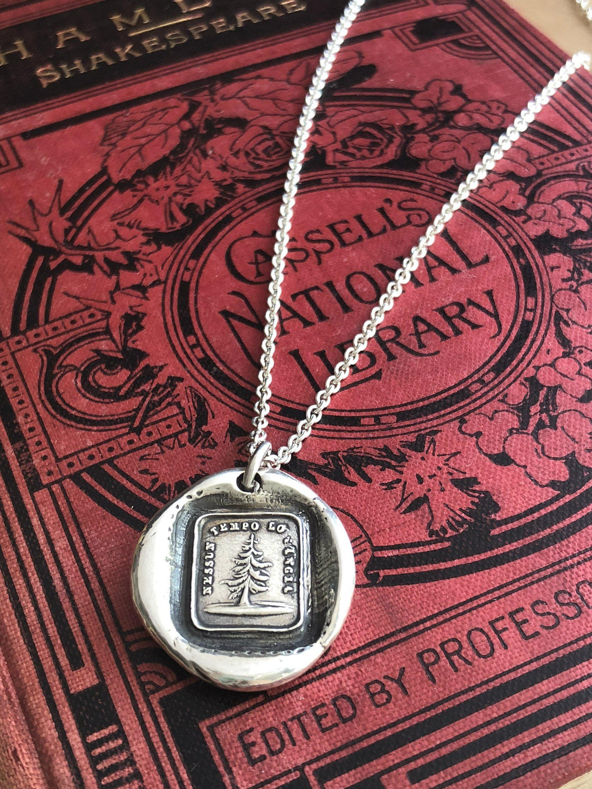 Leaning tree wax seal with a silver chain