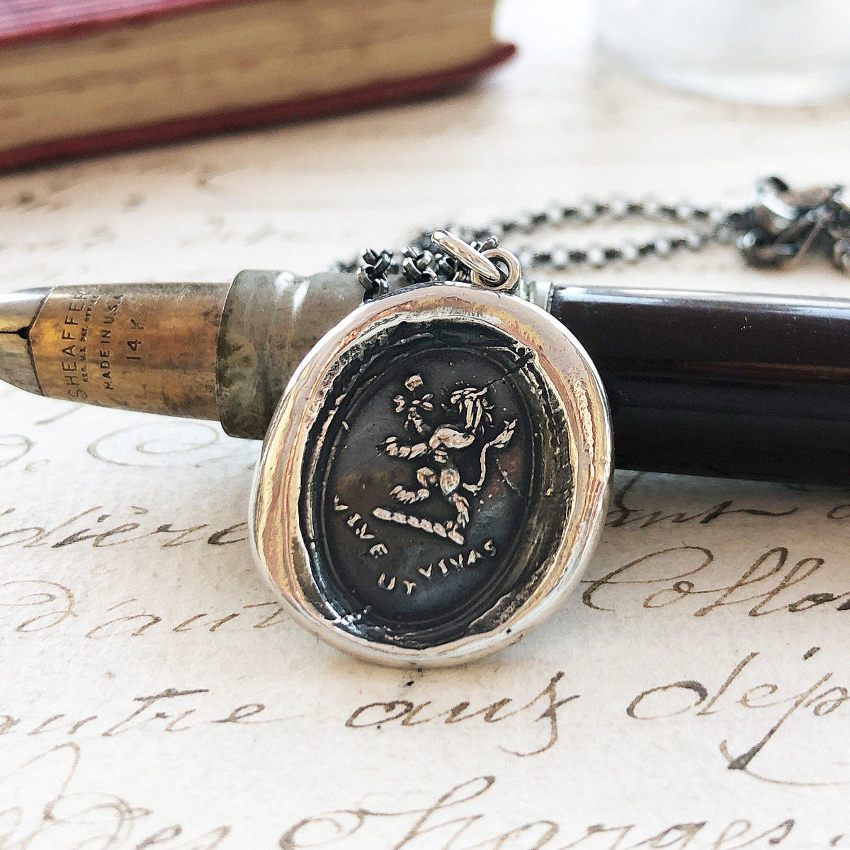 Lion rose wax seal on a pen