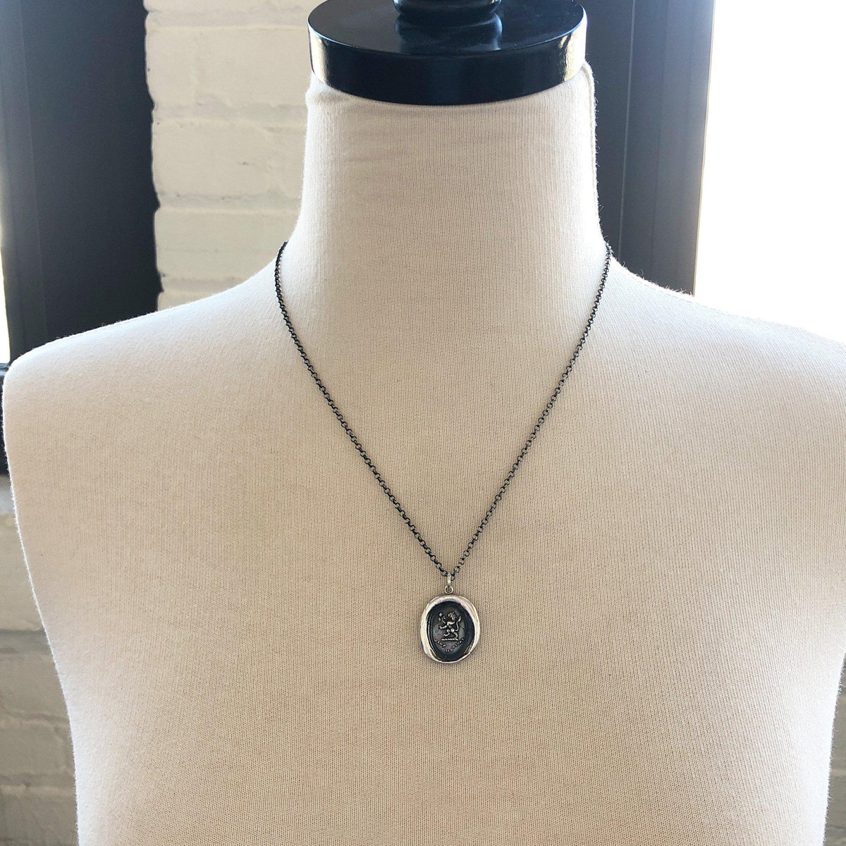 Lion rose wax seal on a mannequin