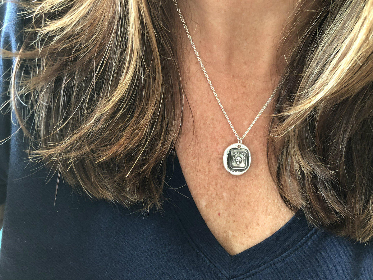 momento skull wax seal necklace on a model