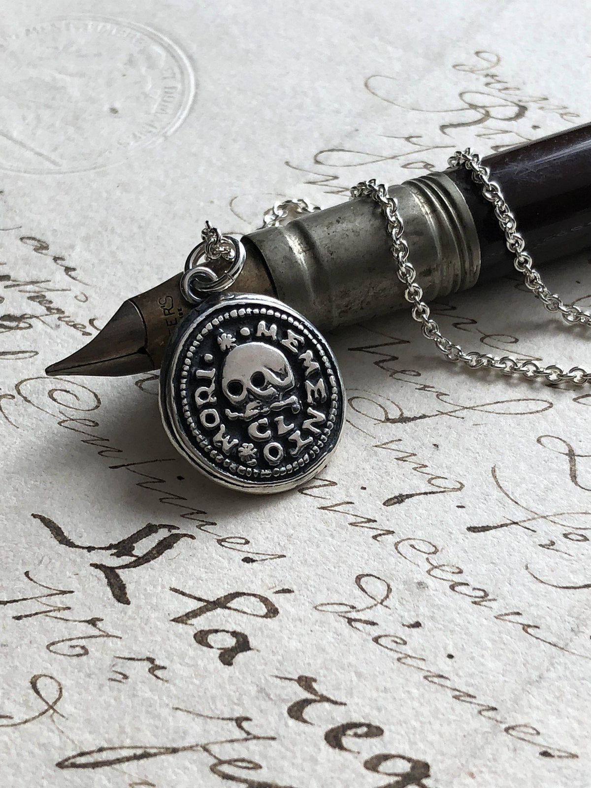 Skull on this wax seal necklace dark pen