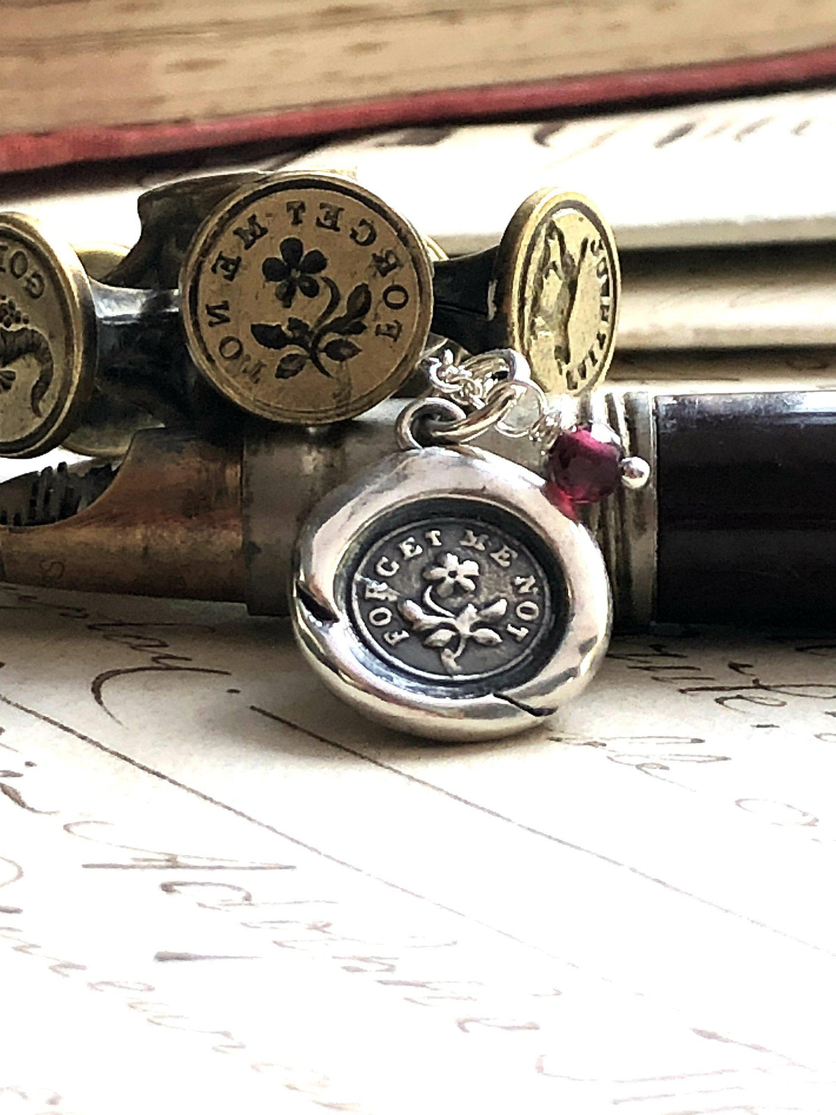flower forget me not wax seal necklace on a pen