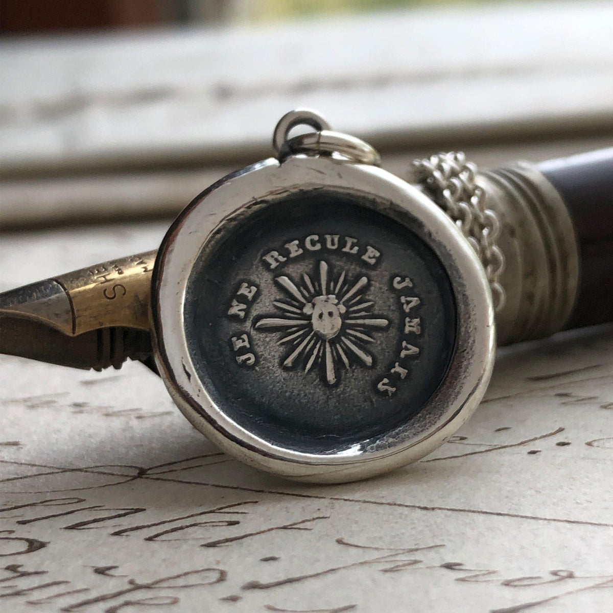 Never back down wax seal necklace over pen