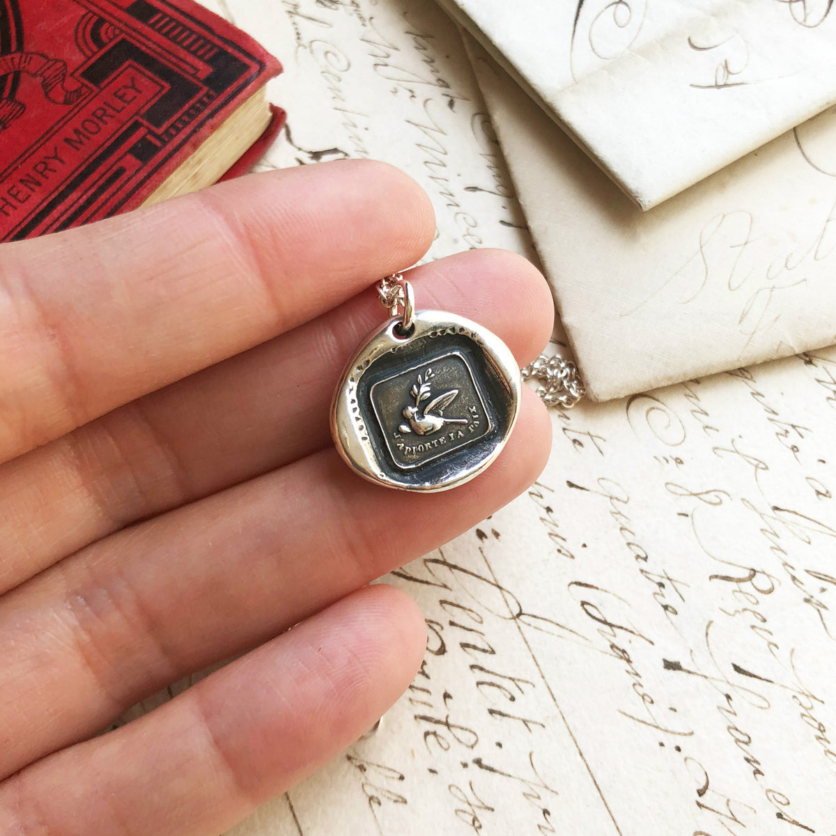 Peace dove necklace in hand