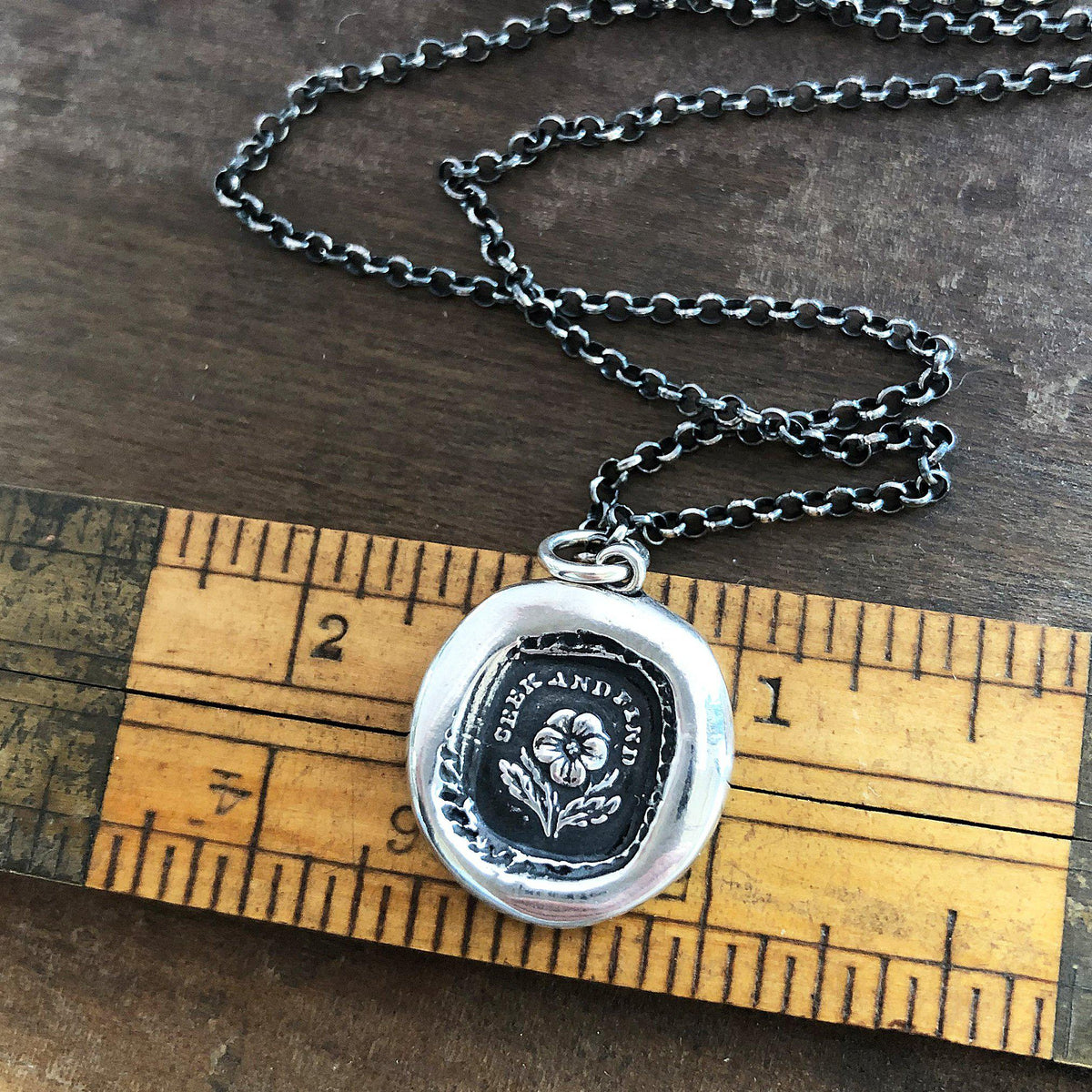 Flower wax seal on a ruler