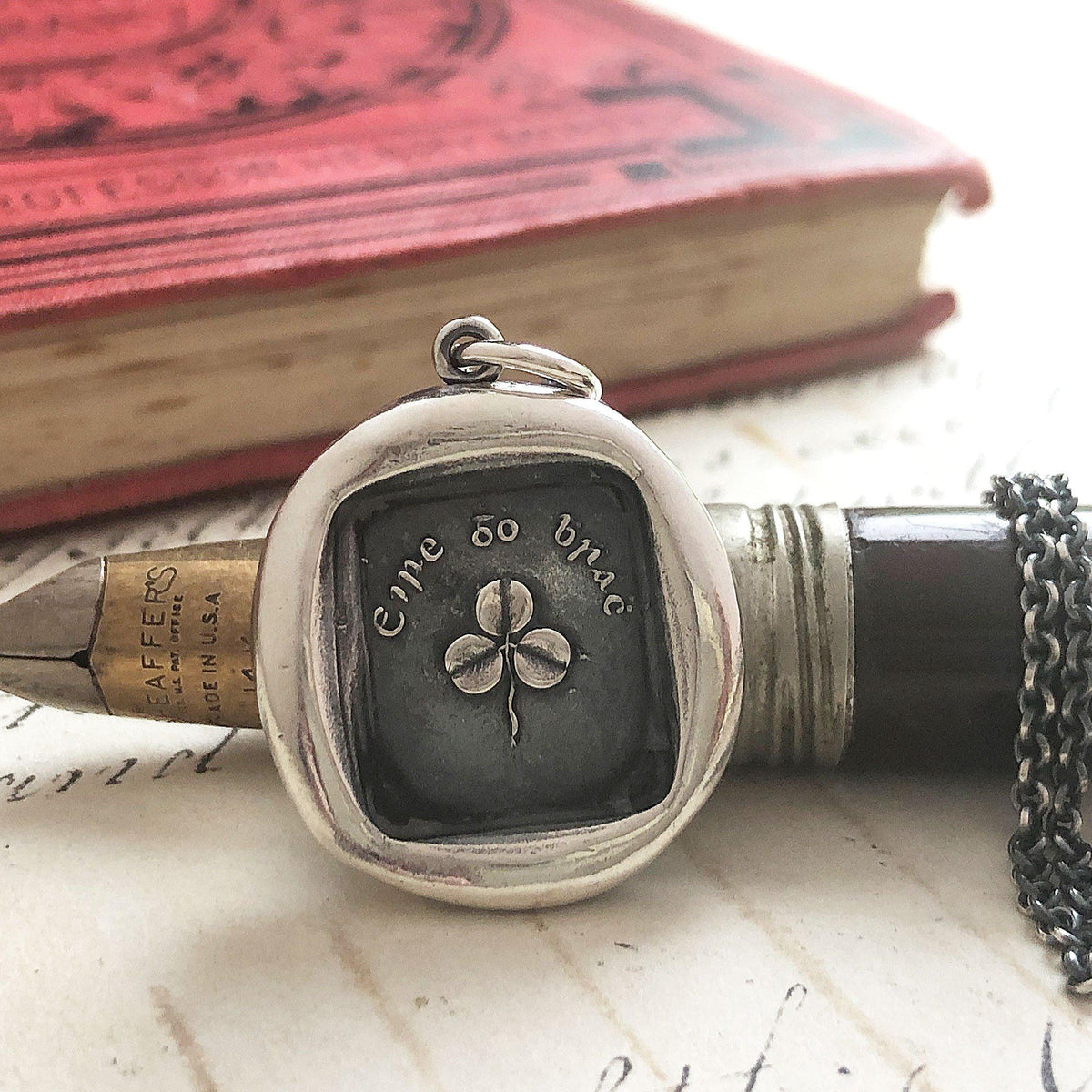 Shamrock wax seal necklace on a pen