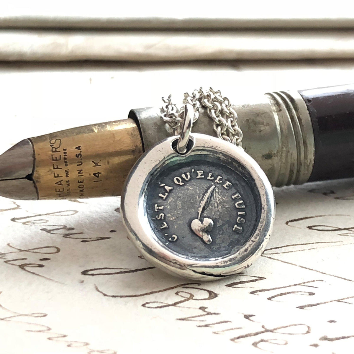 Sincere wax seal necklace on a pen