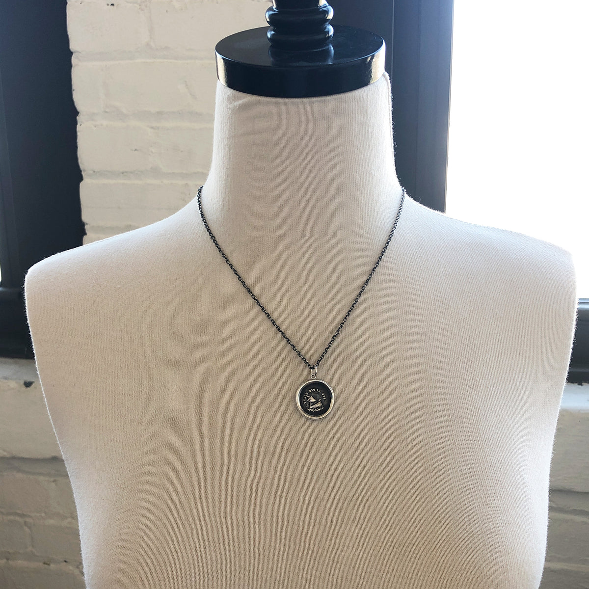 Such is life wax seal necklace on a mannequin