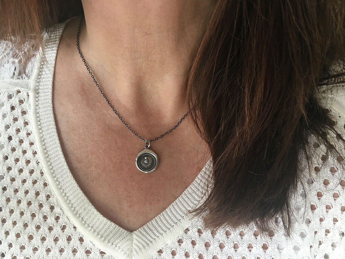Scottish Thistle wax seal necklace on a model