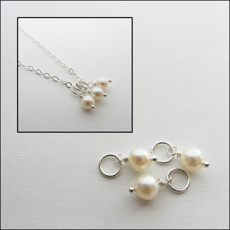 Picture of fresh water pearls separated and attached to a necklace. 