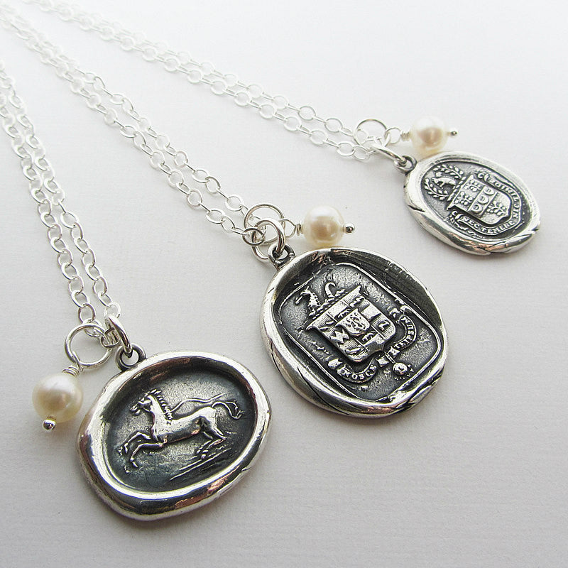 Wax seal necklaces with freshwater pearls attached. 